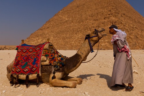 Camel man and his camel posed in front of Khafre’s pyramid, Gi