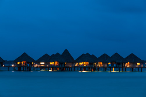 Night view of overwater bungalows of Le Méridien Bora Bora
