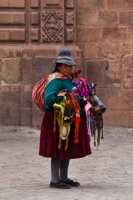Women in traditional costumes selling textiles, Plaza de Armas,