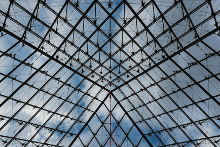 Look through the Louvre Pyramid in Palais du Louvre, Paris